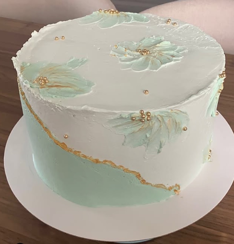 Bolo branco e verde-água com flores pintadas à espátula e pérolas douradas